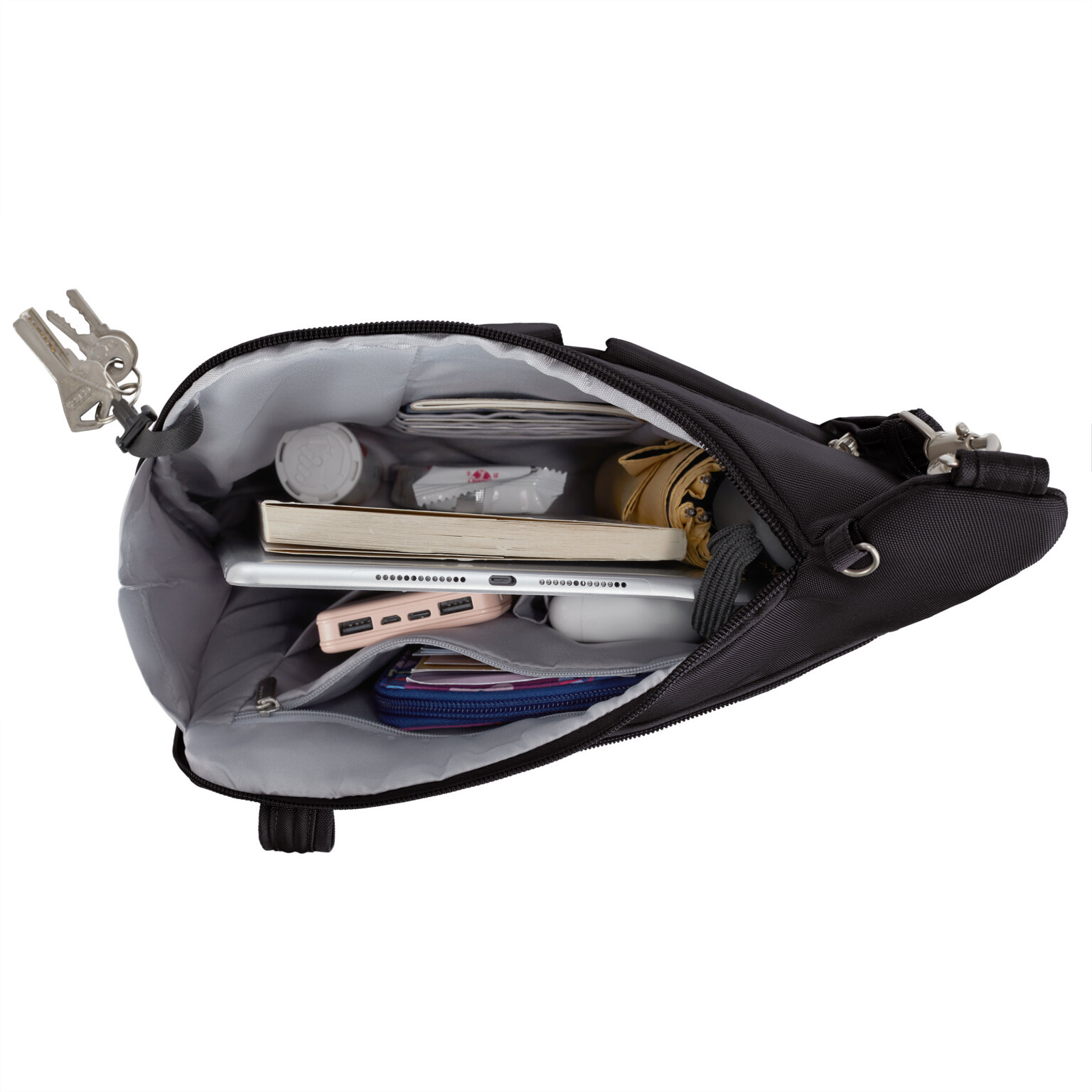 Hoofdvak van de Travelon Classic grote crossbody tas in zwart met tablet, sleutels en verzorgingsspullen